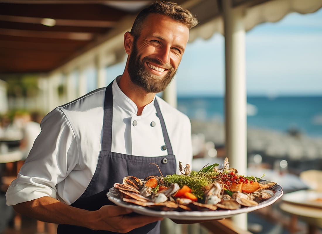 Insurance by Industry - Cheerful Chef Serving Lobster
